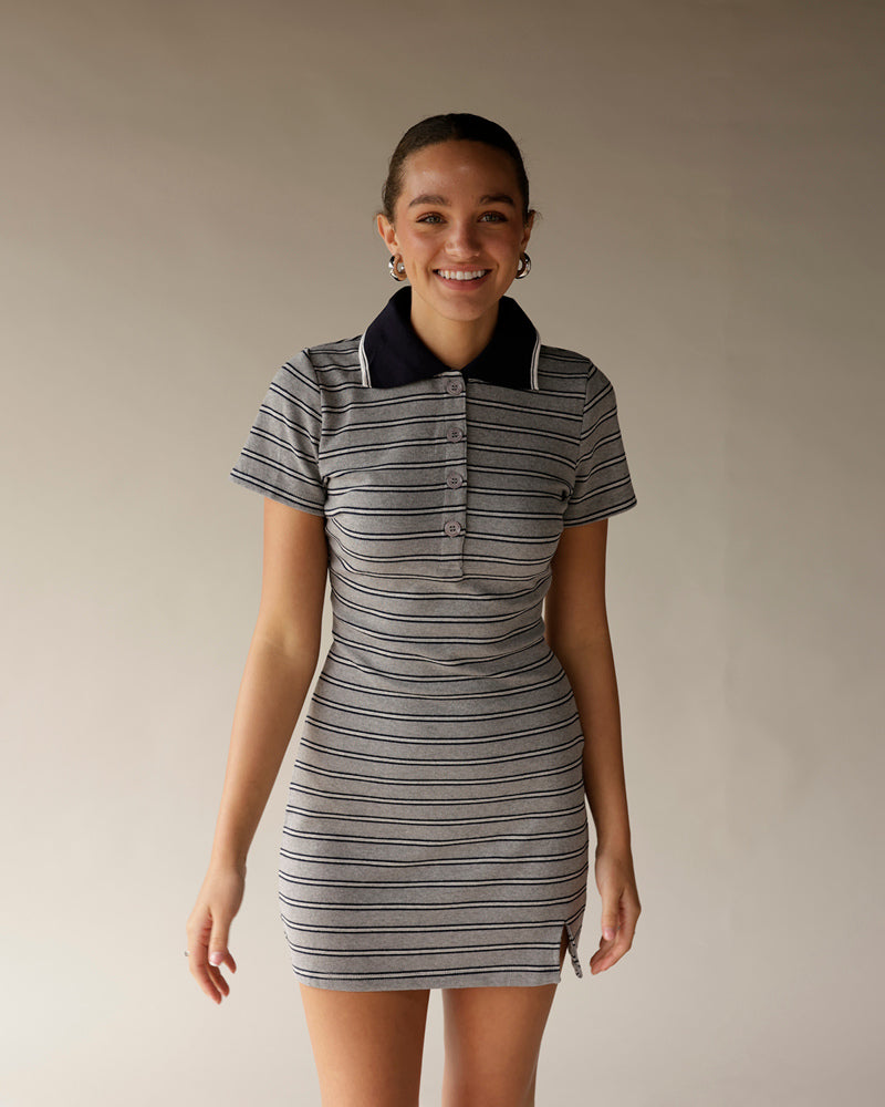 Gray striped polo mini dress with navy collar, short sleeves, and button placket