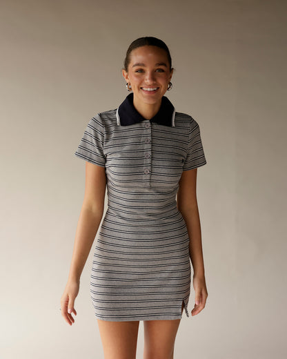 Gray striped polo mini dress with navy collar, short sleeves, and button placket