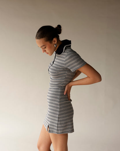 Gray striped mini polo dress with black collar, short sleeves, and side slit