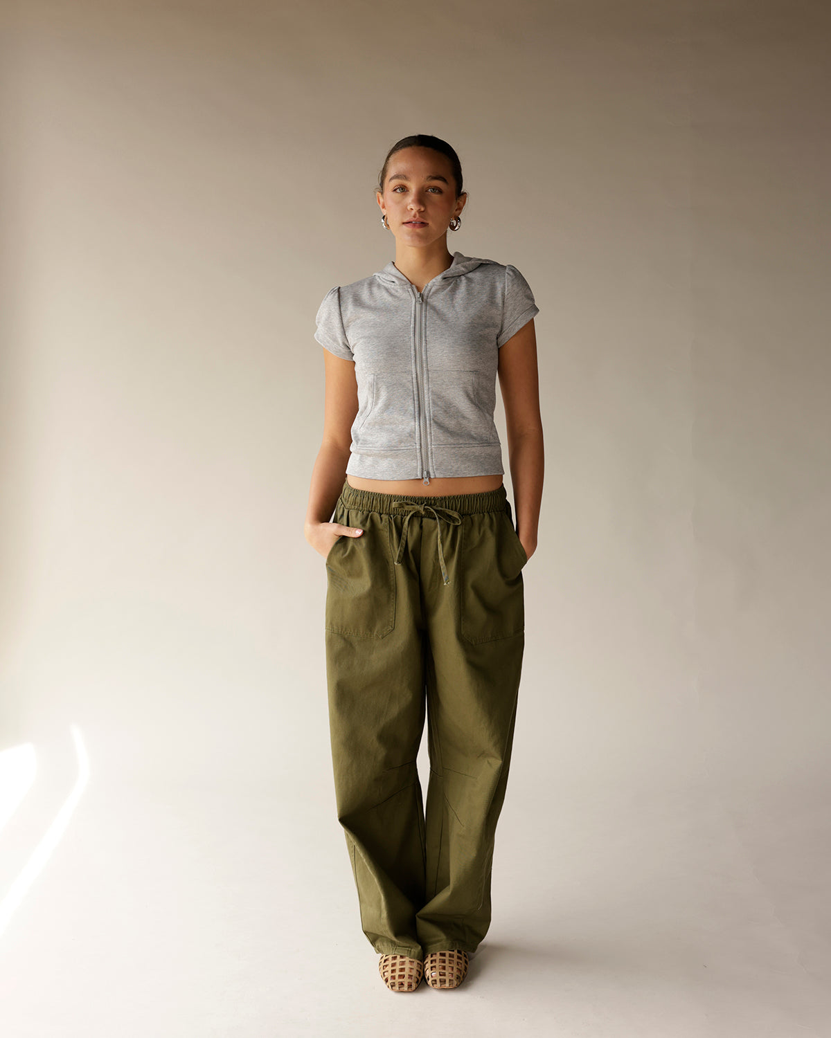 Olive green wide-leg cargo barrel pants with elastic drawstring waist and side pockets