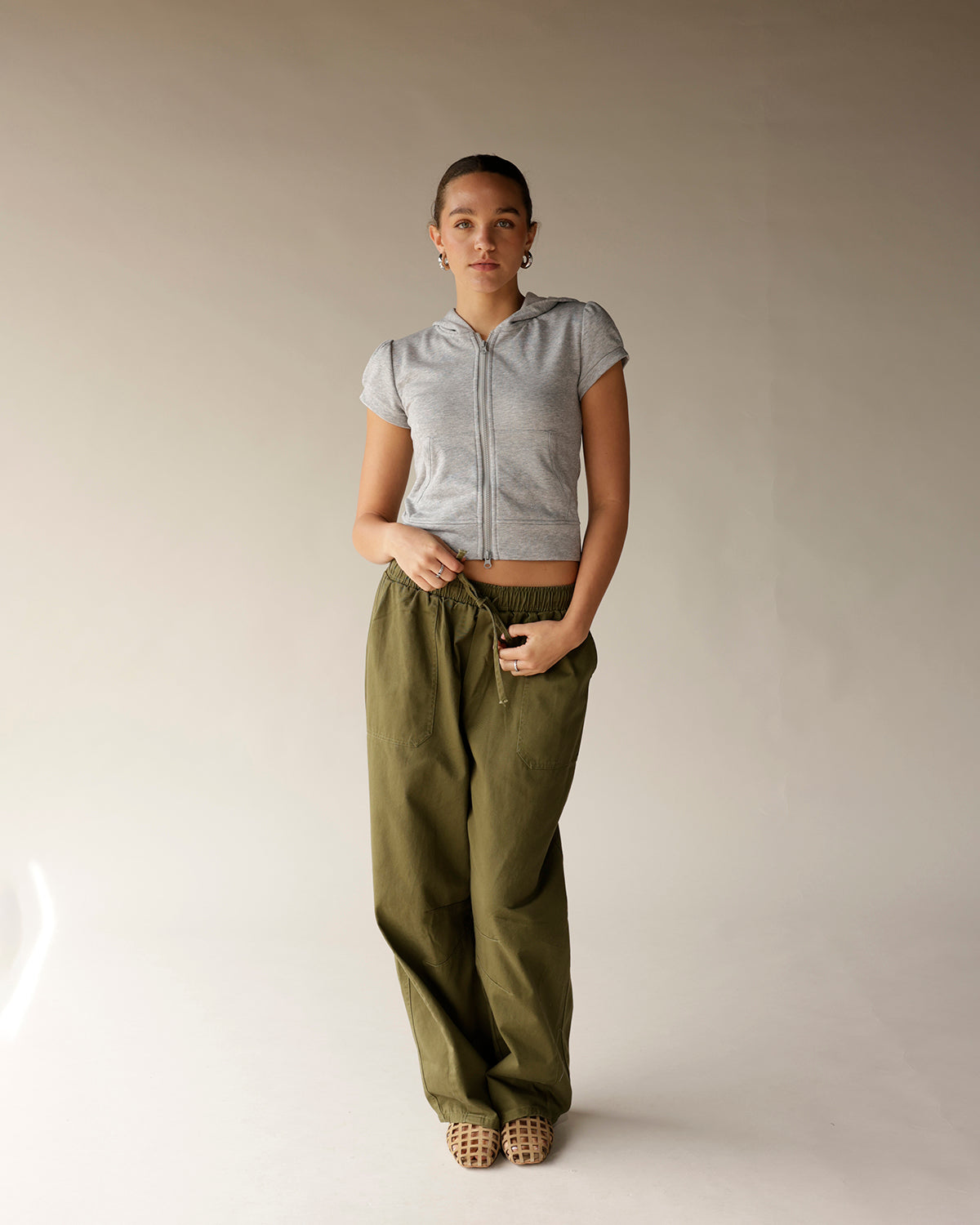 Olive green cargo barrel pants with elastic waistband and drawstring, wide leg fit