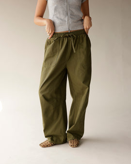Olive green cargo barrel pants with drawstring waist and wide leg fit