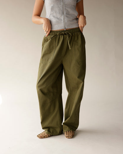 Olive green cargo barrel pants with drawstring waist and wide leg fit