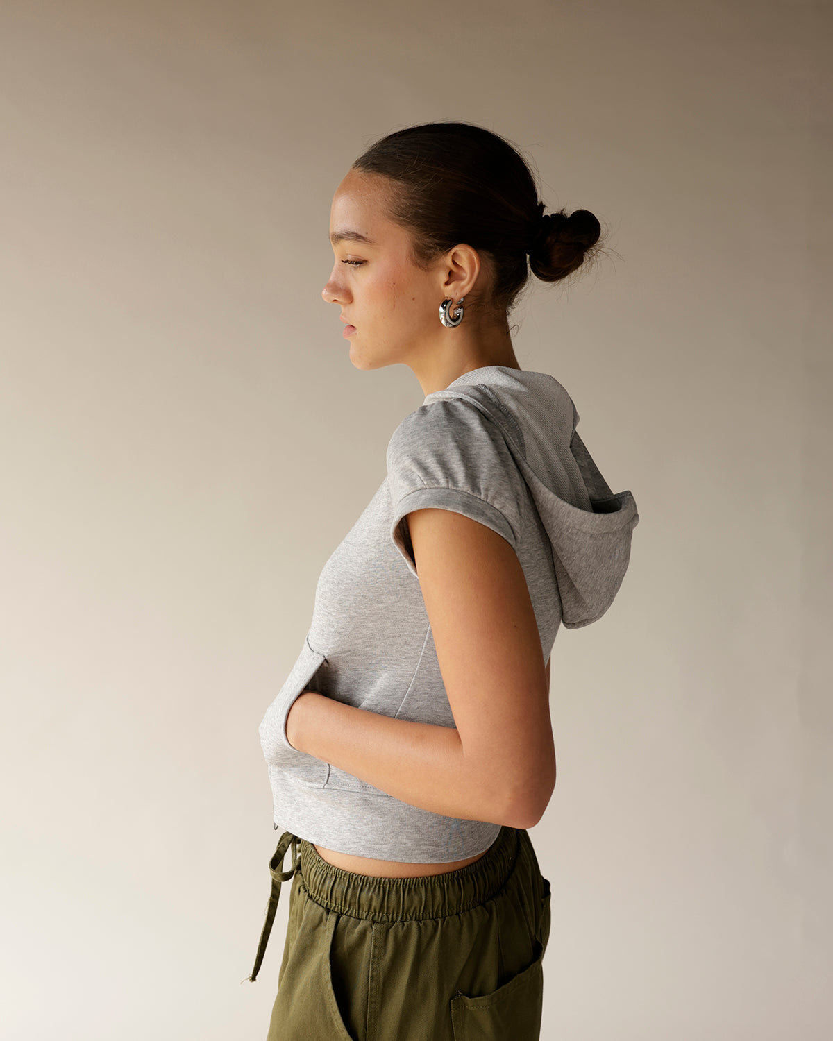 Gray cropped short sleeve hoodie with fitted silhouette and hood, side view