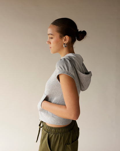 Gray cropped short sleeve hoodie with fitted silhouette and hood, side view