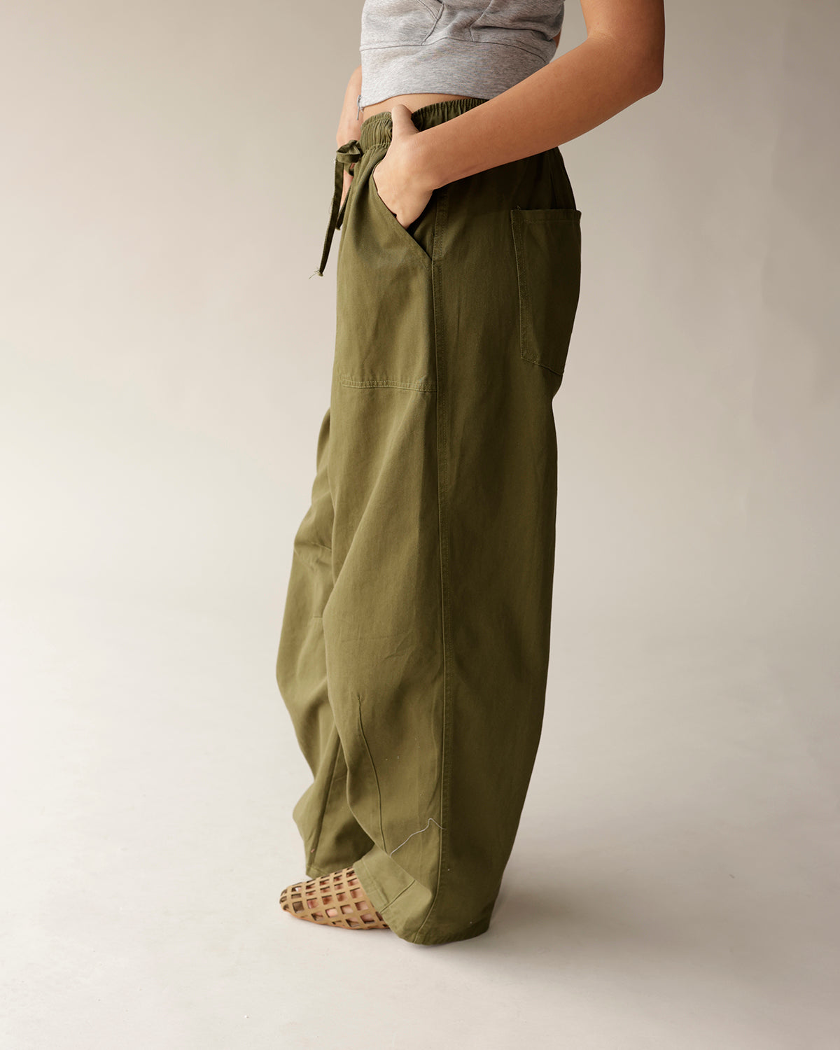 Olive green cargo barrel pants with elastic drawstring waist and wide leg fit