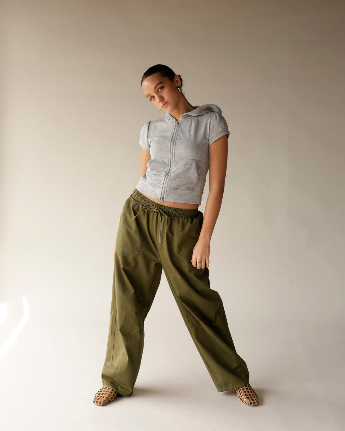 Olive green cargo barrel pants with elastic drawstring waist and wide leg fit
