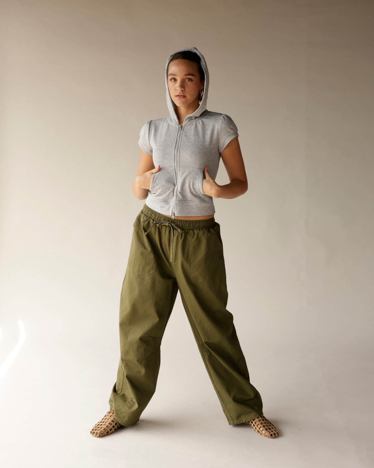 Olive green wide-leg cargo barrel pants with drawstring waist and side pockets