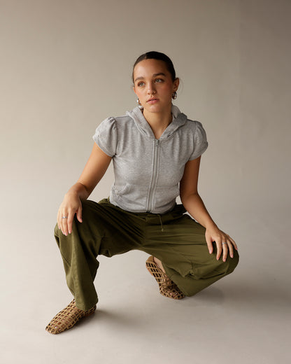 Olive green cargo barrel pants with drawstring waist, worn in a cropped styling.