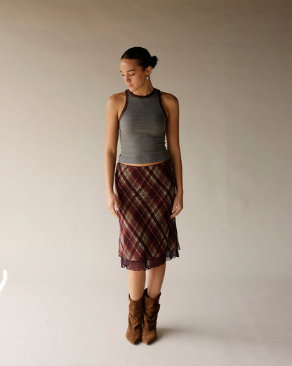 Gray ribbed sleeveless tank top with brown trim neckline, worn with plaid skirt