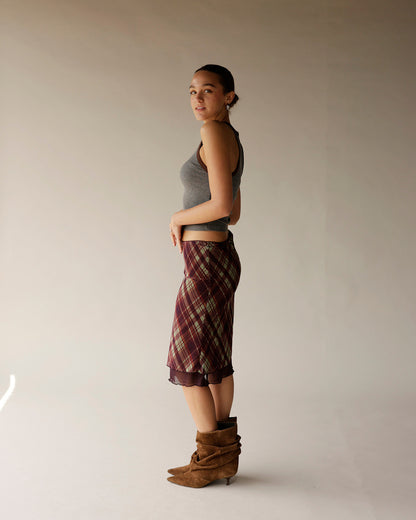 Gray ribbed sleeveless crop tank top styled with plaid midi skirt and brown boots