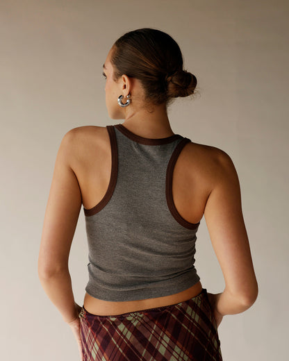 Gray ribbed racerback tank top with brown contrast trim, worn with plaid skirt