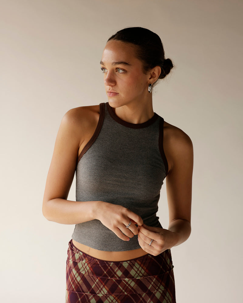 Gray ribbed crop tank top with dark brown contrast trim at neckline and armholes