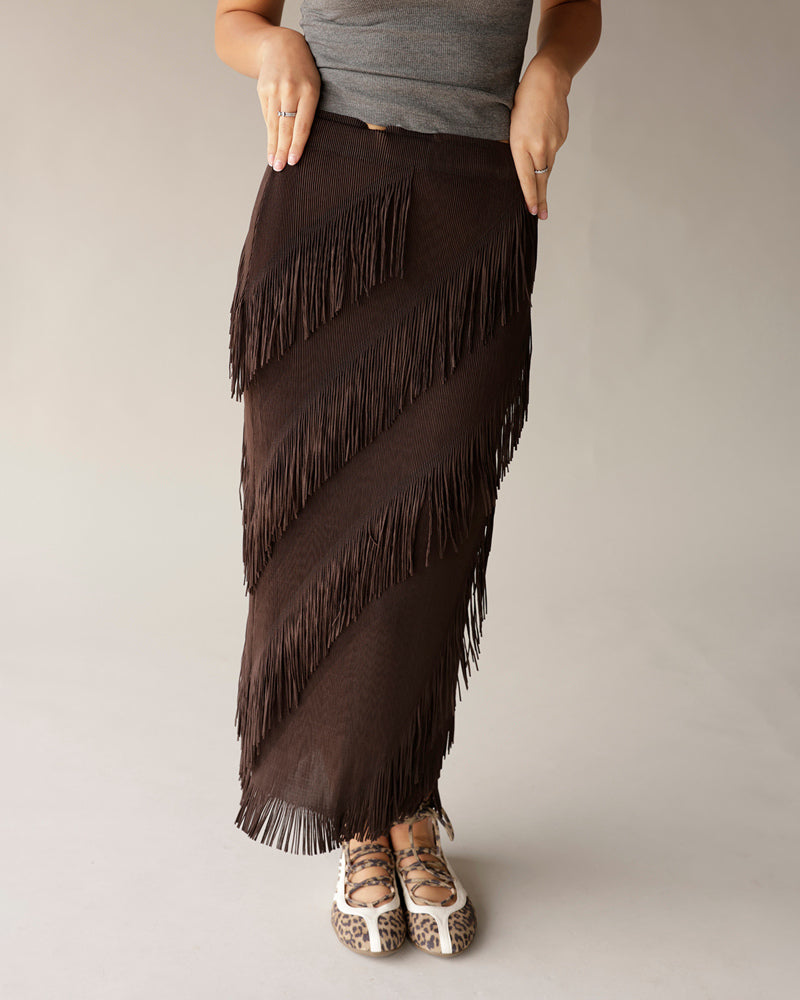 Dark brown fringed maxi skirt with diagonal fringe layers, paired with leopard flats