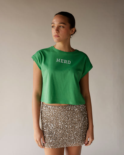 Kelly green cropped muscle tee with white HERD graphic on chest