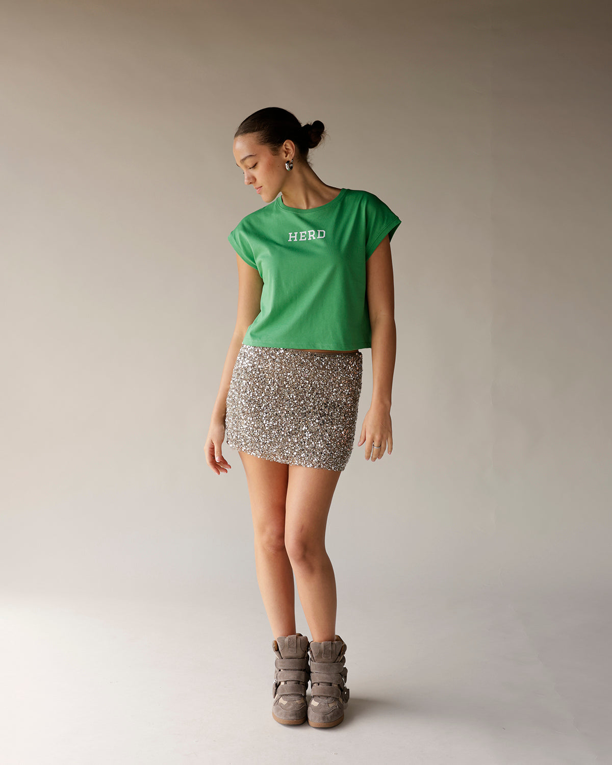 Kelly green cropped muscle tee with white HERD text on chest