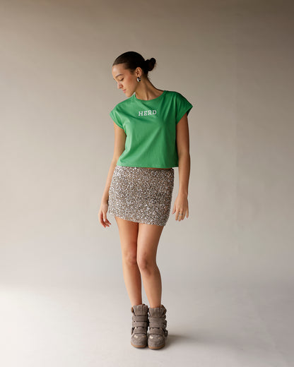 Kelly green cropped muscle tee with white HERD text on chest