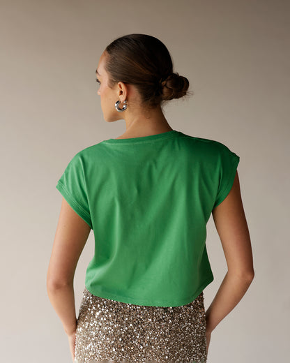 Women's kelly green cropped muscle tee with rolled sleeves, back view