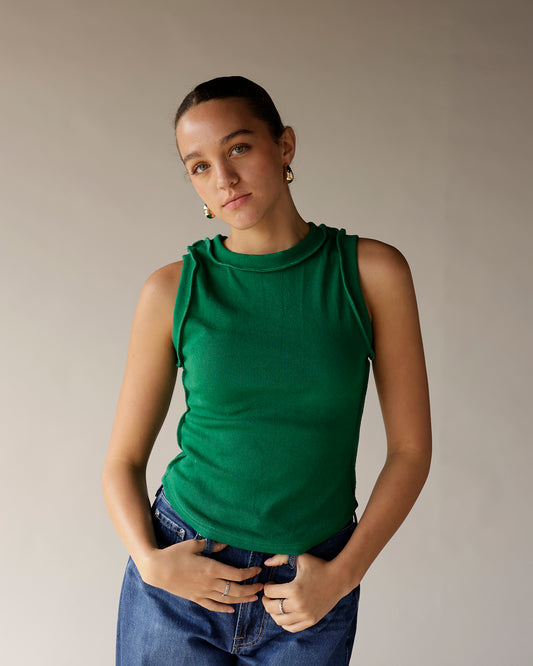 Green ribbed sleeveless tank top with mock neck and ruffled shoulder detail