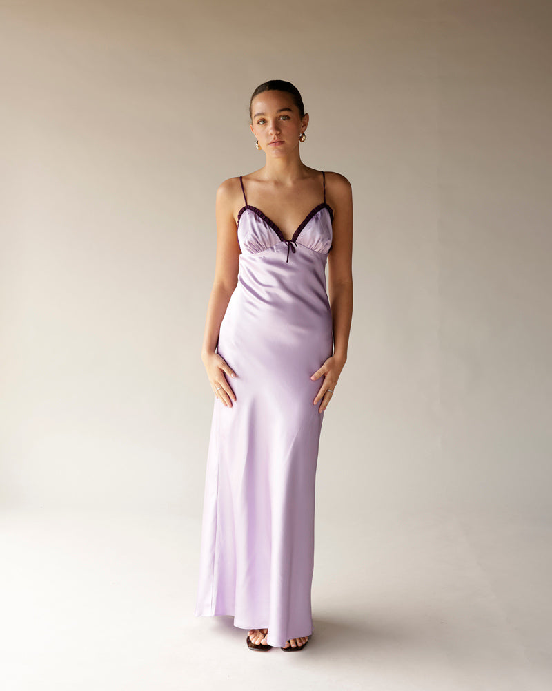 Lilac satin midi slip dress with dark lace trim, spaghetti straps, and side slit