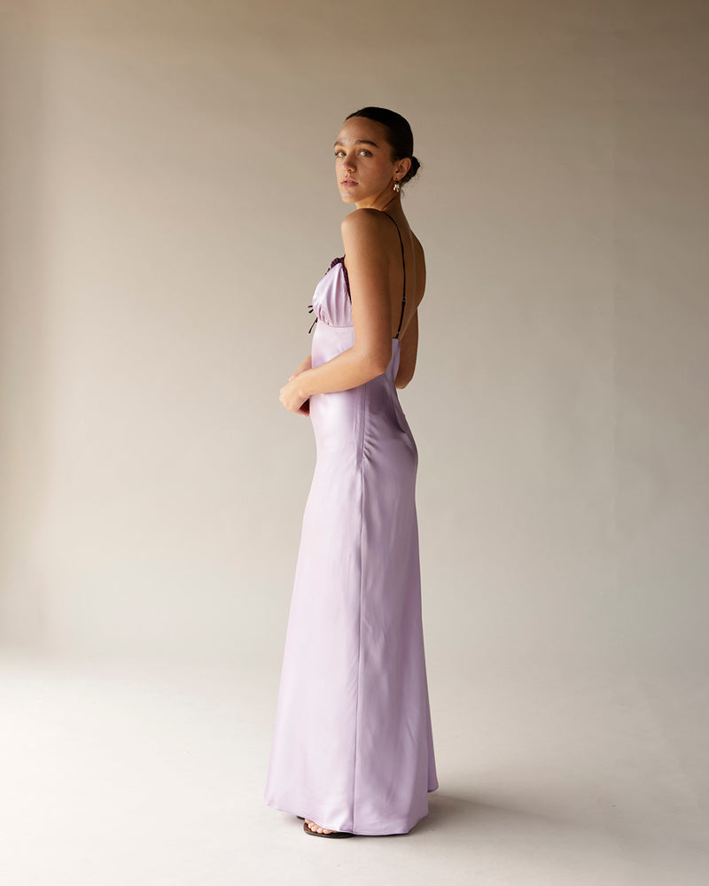 Lilac satin midi dress with open back, thin straps, and fitted silhouette