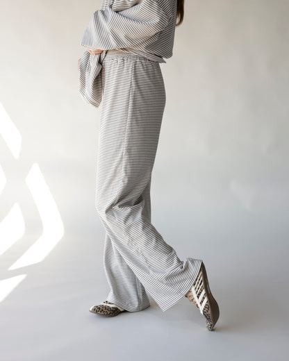Gray and white striped wide-leg lounge pants with elastic waistband, worn with leopard flats
