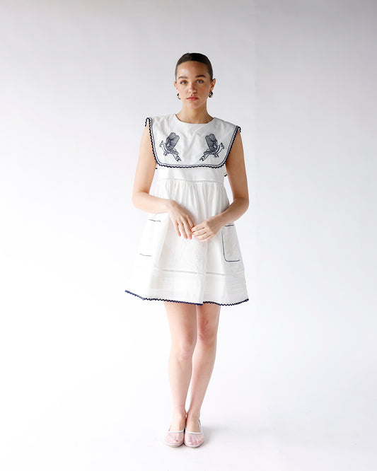 white sleeveless mini dress navy blue embroidered details peter pan collar white and navy mini dress
