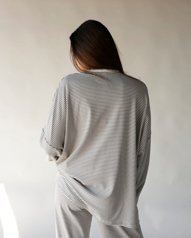 Gray and white striped lounge pants and matching top, rear view