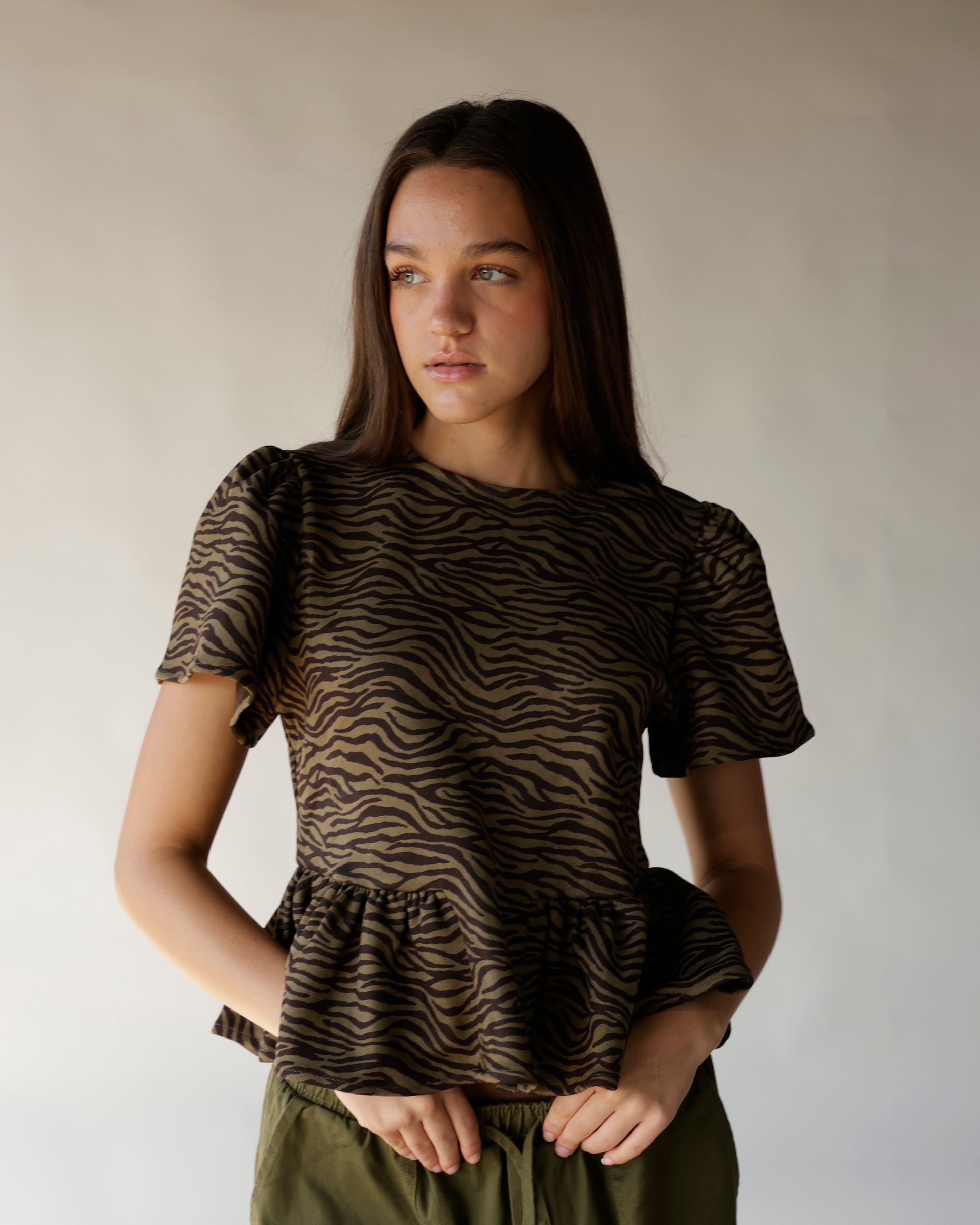 Brown and black zebra print short sleeve peplum top with ruffle hem