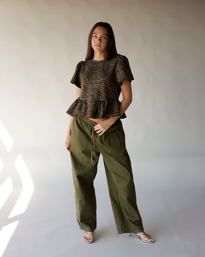 Brown and black zebra print short sleeve peplum top with ruffle hem