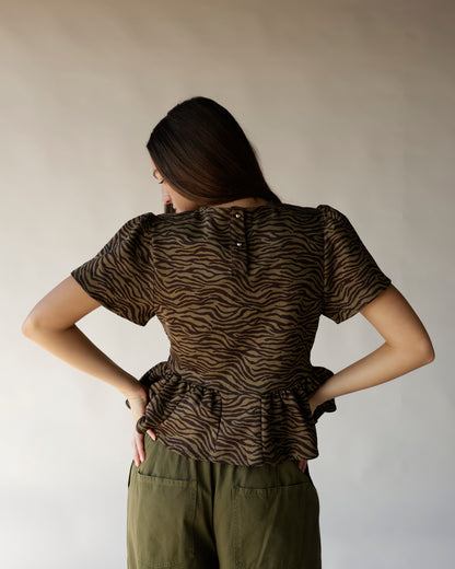 Brown and black zebra print peplum top with short sleeves and back button detail