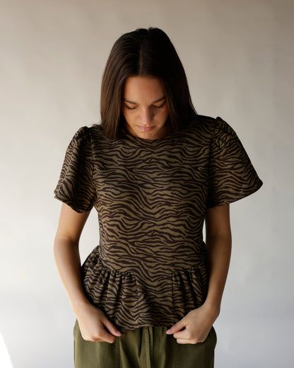 Brown and black zebra print peplum top with puff sleeves and ruffle hem