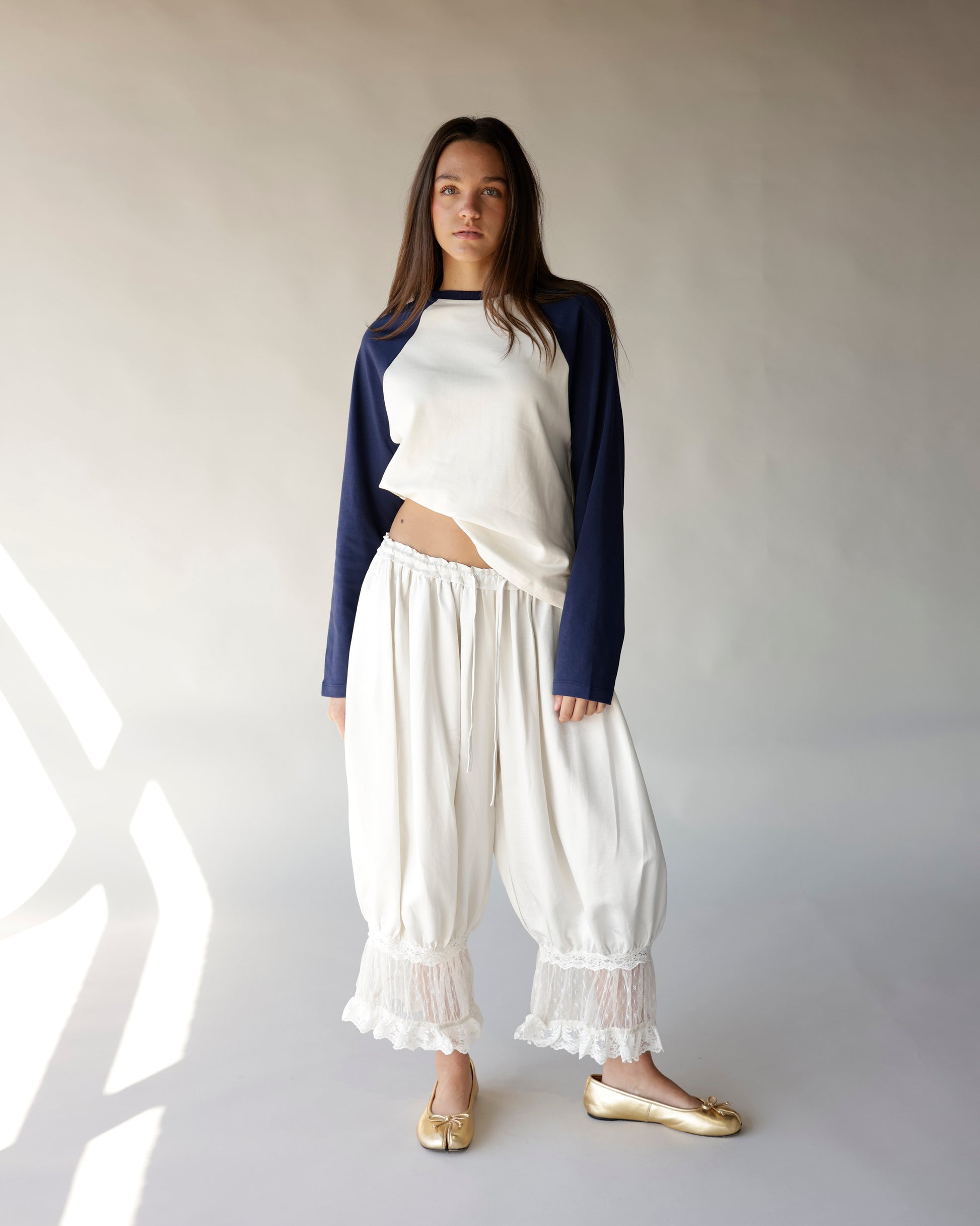 White and royal blue raglan long-sleeve crop top with lace-trim cream pants