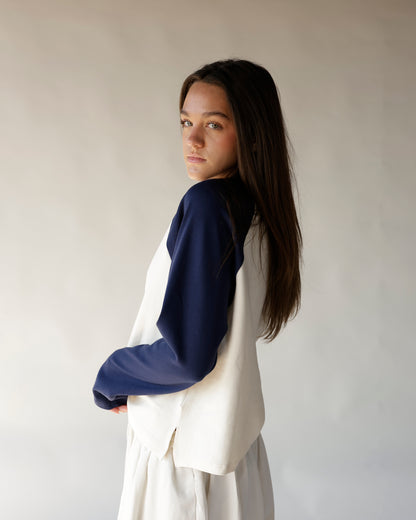Navy and cream raglan sweatshirt, colorblock sleeves, relaxed fit, worn from behind