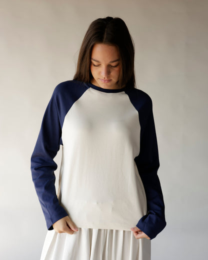 Navy blue and cream long sleeve raglan baseball tee on female model
