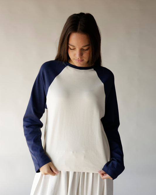 Navy blue and cream long sleeve raglan baseball tee on female model