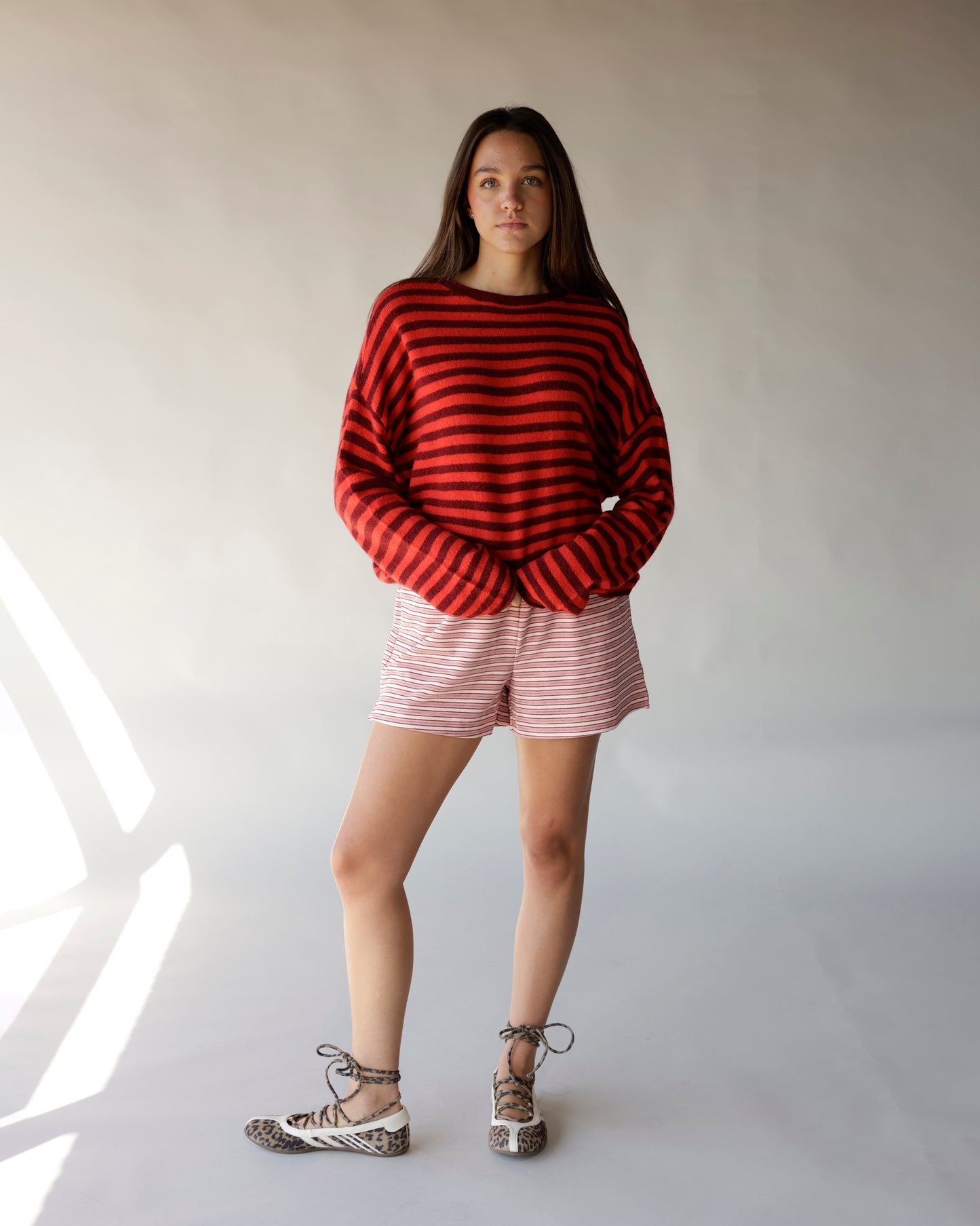 Red and burgundy striped oversized mock neck sweater with drop shoulders