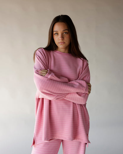 Oversized pink striped long sleeve tee with relaxed fit and side slits
