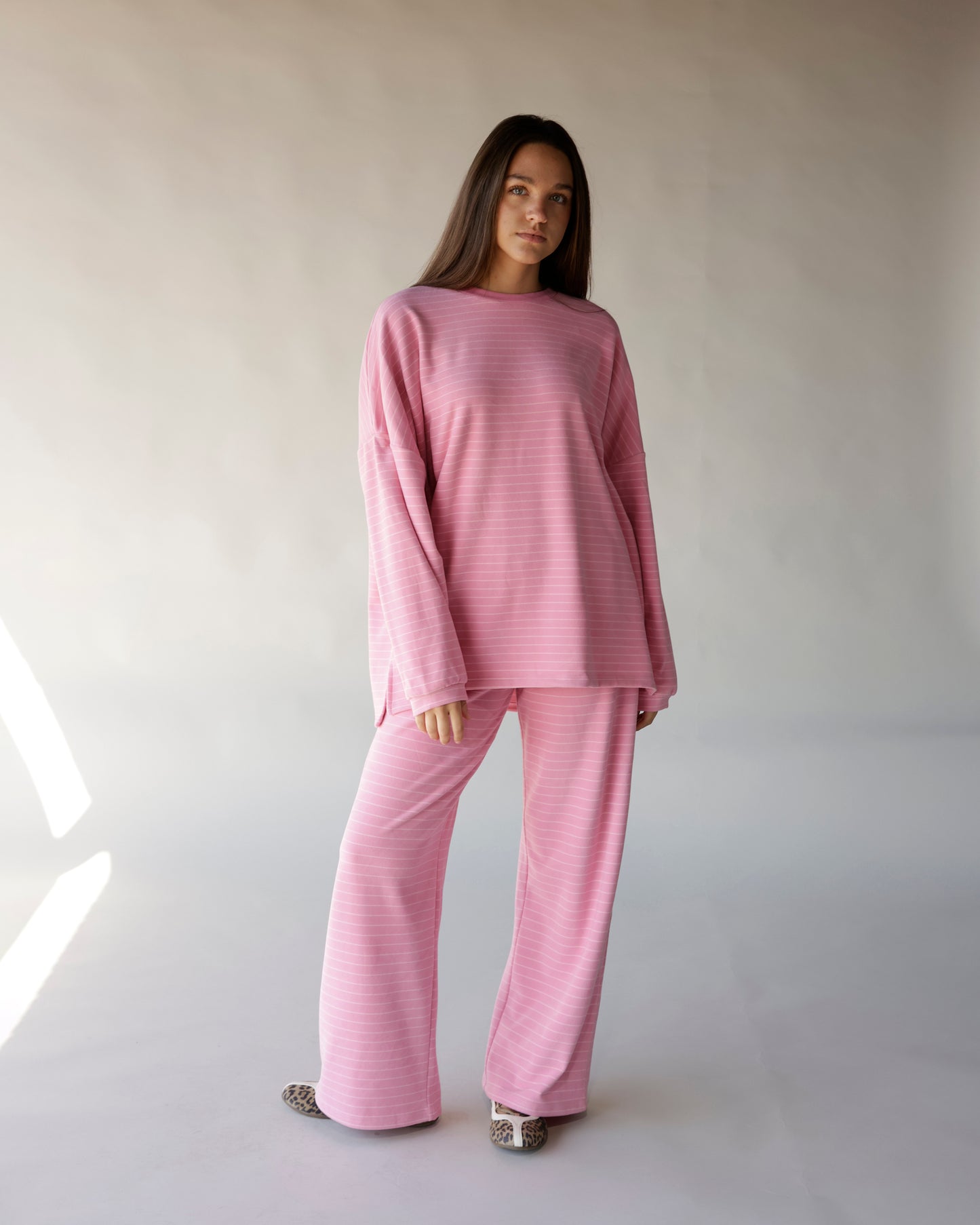 Pink striped wide-leg lounge pants with matching oversized long-sleeve top