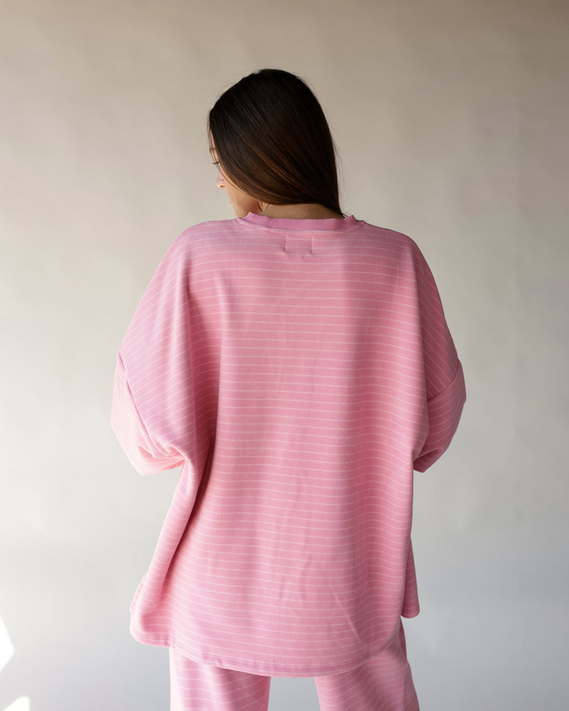 Oversized pink striped long sleeve tee, relaxed fit, shown from the back.