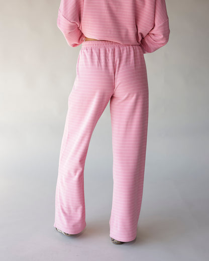 Pink striped wide-leg lounge pants with elastic waistband, back view