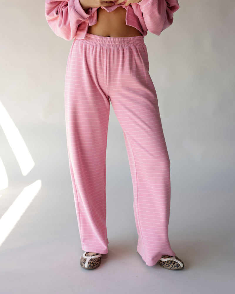 Pink striped wide-leg lounge pants with elastic waist, styled with matching pink top