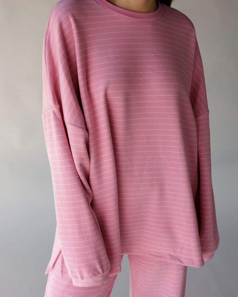 Oversized pink striped long sleeve crew neck tee with relaxed fit and side slits