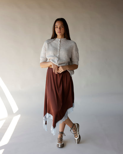Gray short-sleeve ribbed knit cardigan with small buttons, worn with brown midi skirt