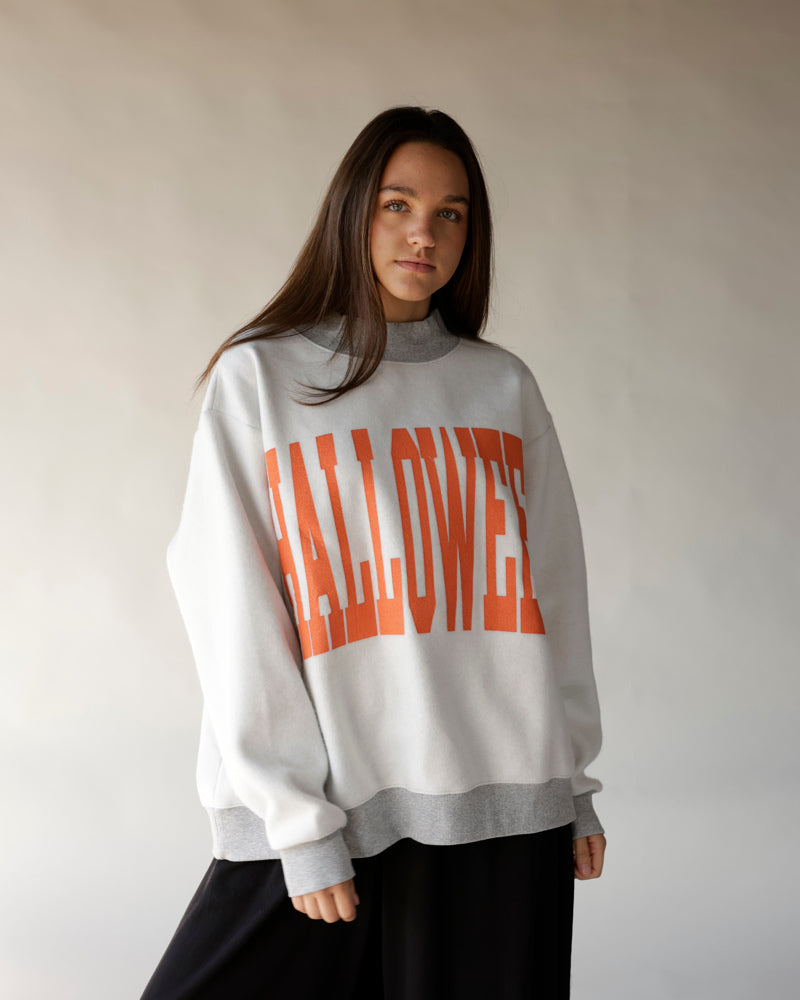 White and gray reversible mock neck sweatshirt with bold orange HALLOWEEN graphic print