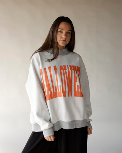 White and gray reversible mock neck sweatshirt with bold orange HALLOWEEN graphic print