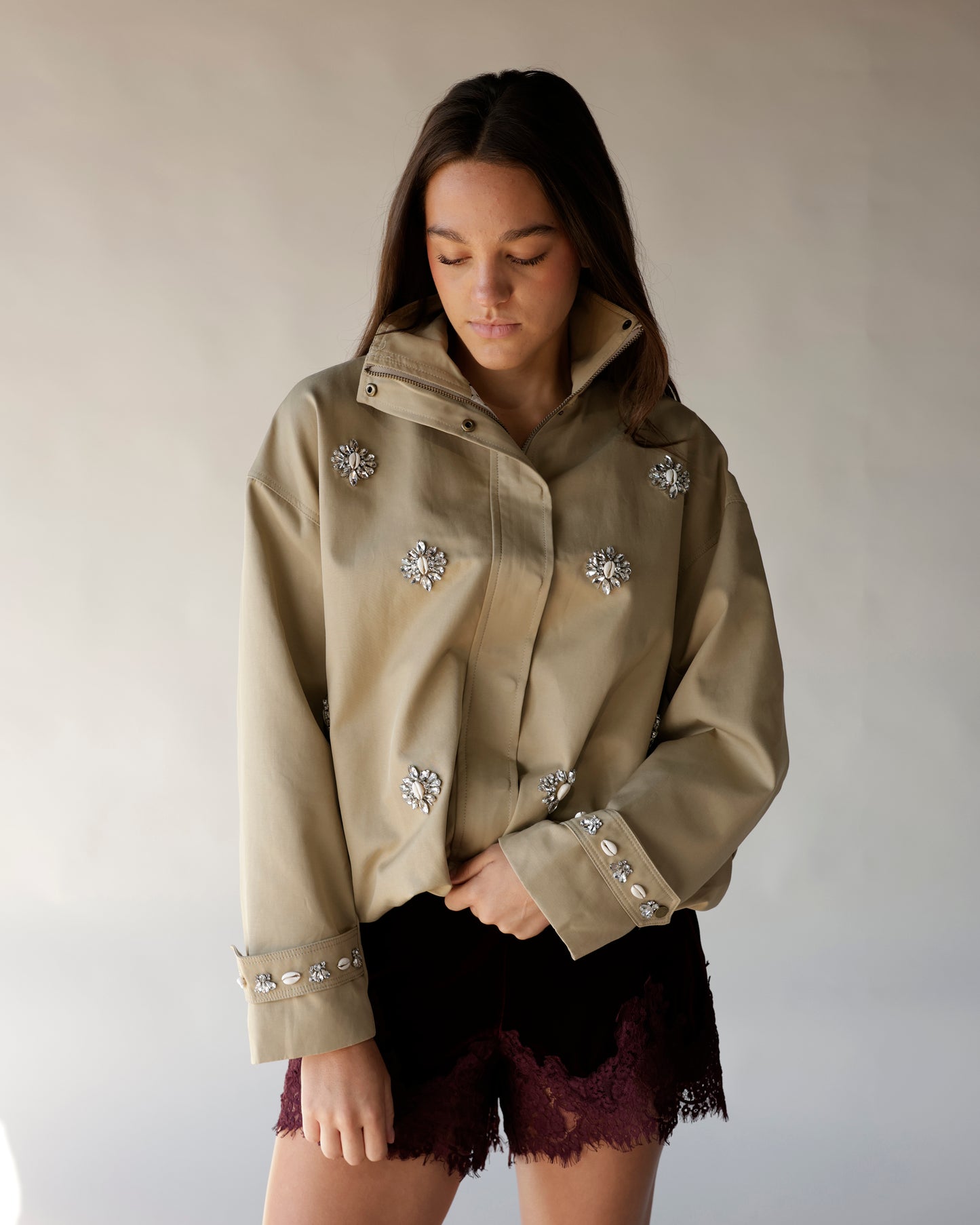 Maroon velvet shorts with lace hem, styled with embellished khaki jacket