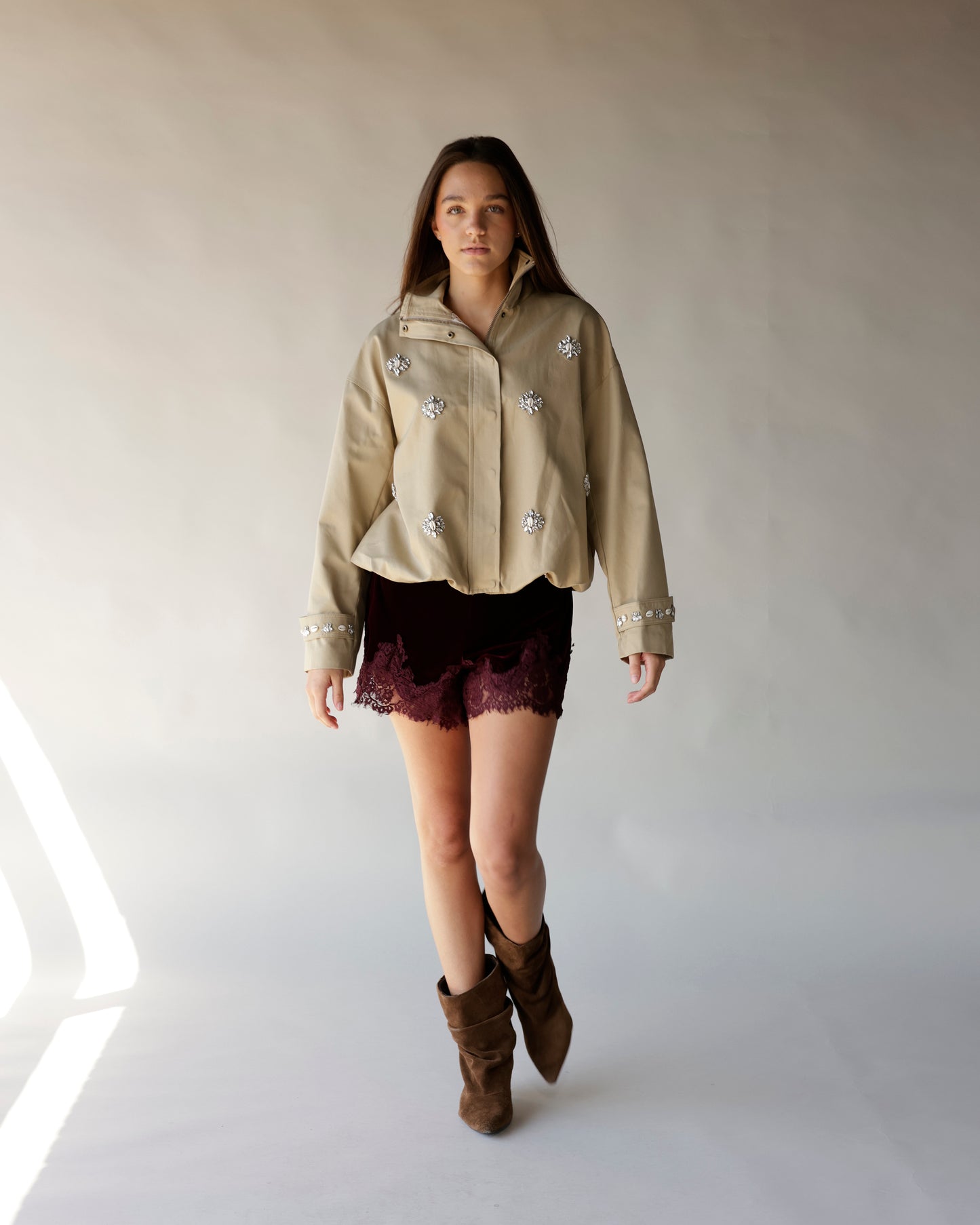 Maroon velvet mini shorts with burgundy lace hem detail, worn with boots