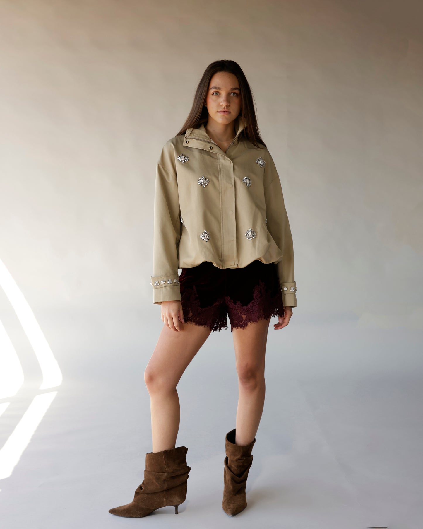Maroon velvet shorts with lace scalloped hem, worn with khaki jacket and brown boots