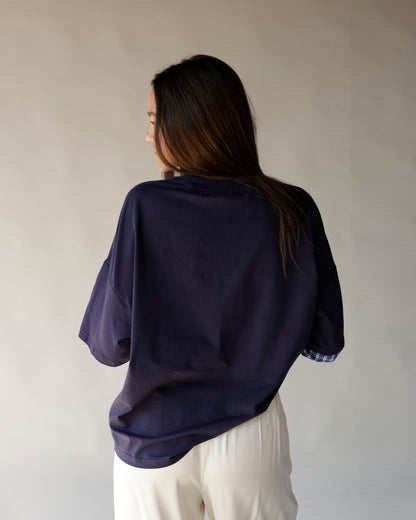Women's oversized navy blue short sleeve top with plaid cuff detail, back view